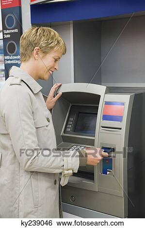 Woman inserting a credit card into ATM View Large Photo Image Stock Photograph - Woman inserting a credit card into ATM. Fotosearch