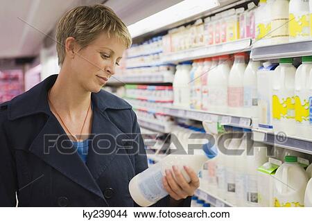 Woman shopping in a supermarket View Large Photo Image Picture - Woman shopping in a supermarket. Fotosearch