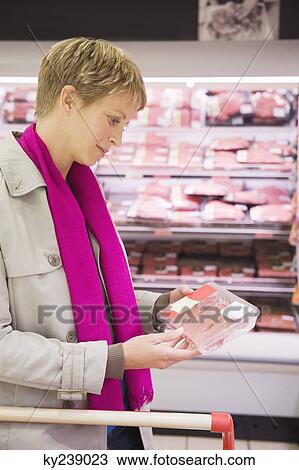 Woman shopping in a supermarket View Large Photo Image Stock Image - Woman shopping in a supermarket. Fotosearch