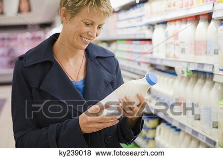 Woman shopping in a supermarket View Large Photo Image Stock Photo - Woman shopping in a supermarket. Fotosearch