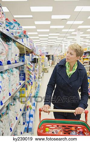 Stock Photo - Woman shopping in a supermarket. Fotosearch