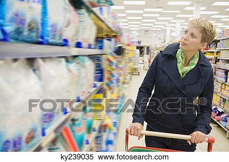 Woman shopping in a supermarket View Large Photo Image Stock Photography - Woman shopping in a supermarket. Fotosearch