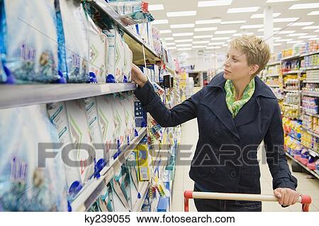 Woman shopping in a supermarket View Large Photo Image Stock Photography - Woman shopping in a supermarket. Fotosearch