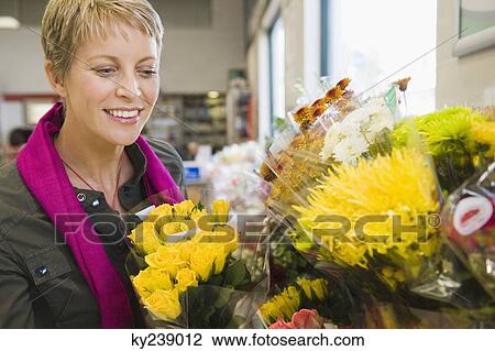 Woman smiling in a florist shop View Large Photo Image Stock Image - Woman smiling in a florist shop. Fotosearch