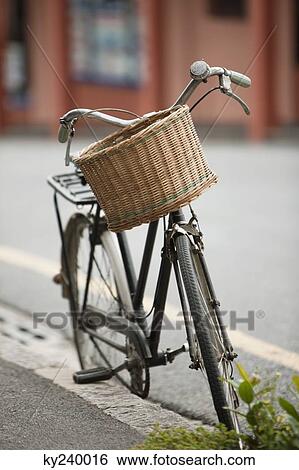 Bicycle parked at the roadside View Large Photo Image Stock Photograph - Bicycle parked at the roadside. Fotosearch
