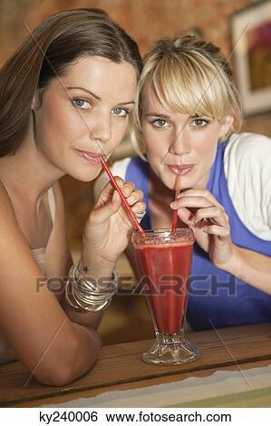 Two women drinking bloody mary in a cafe View Large Photo Image Stock Photograph - Two women drinking bloody mary in a cafe. Fotosearch