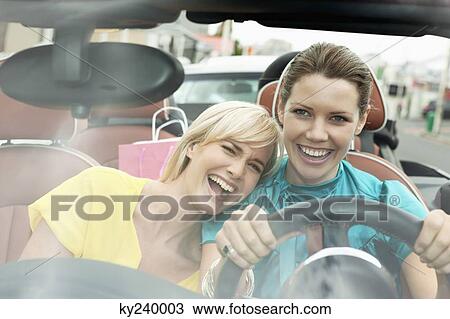 Two women sitting in a car after shopping View Large Photo Image Stock Image - Two women sitting in a car after shopping. Fotosearch