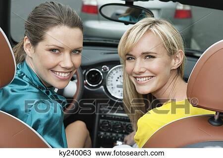 Two women sitting in a car after shopping View Large Photo Image Stock Image - Two women sitting in a car after shopping. Fotosearch