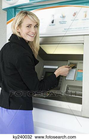 Woman inserting a credit card into ATM View Large Photo Image Stock Image - Woman inserting a credit card into ATM. Fotosearch