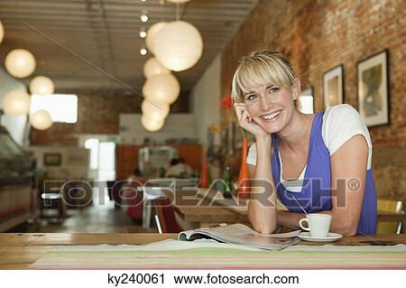 Woman reading a magazine and drinking coffee in a cafe View Large Photo Image Stock Image - Woman reading a magazine and drinking coffee in a cafe. Fotosearch