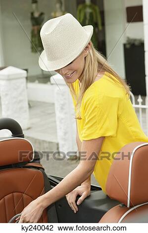 Woman standing near a car after shopping View Large Photo Image Stock Image - Woman standing near a car after shopping. Fotosearch