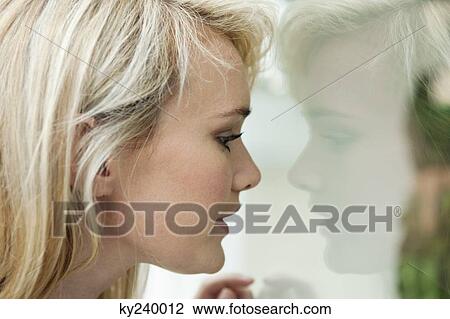 Woman window shopping in a boutique View Large Photo Image Stock Image - Woman window shopping in a boutique. Fotosearch