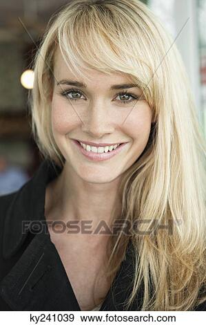 Portrait of a woman smiling in a cafe View Large Photo Image Stock Photo - Portrait of a woman smiling in a cafe. Fotosearch