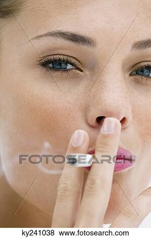 Stock Photo - Portrait of a woman smoking a cigarette. Fotosearch