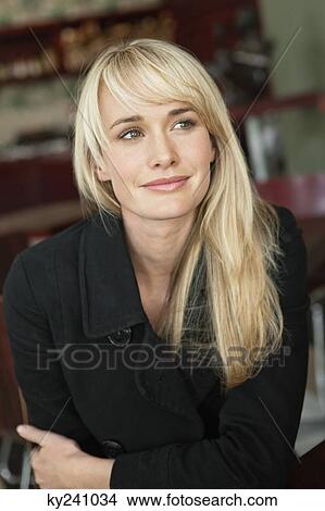 Woman sitting in a cafe and day dreaming View Large Photo Image Picture - Woman sitting in a cafe and day dreaming. Fotosearch