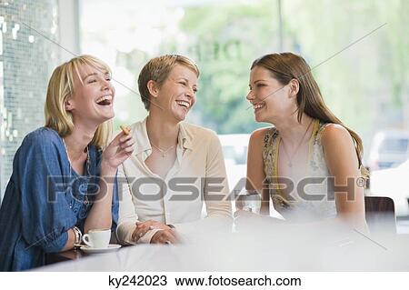 Three women sitting in a restaurant View Large Photo Image Stock Image - Three women sitting in a restaurant. Fotosearch