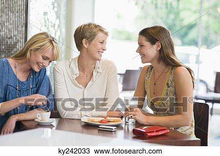Three women sitting in a restaurant View Large Photo Image Stock Image - Three women sitting in a restaurant. Fotosearch