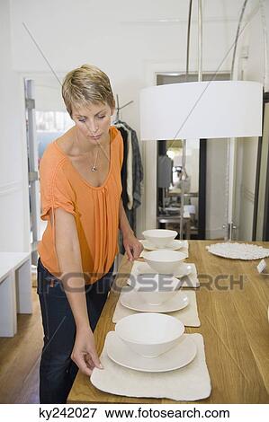 Stock Photo - Woman shopping crockery in a store. Fotosearch