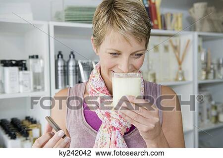 Woman smelling moisturizer in a store View Large Photo Image Stock Image - Woman smelling moisturizer in a store. Fotosearch