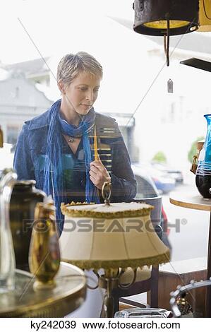 Woman window shopping in a store View Large Photo Image Stock Photo - Woman window shopping in a store. Fotosearch