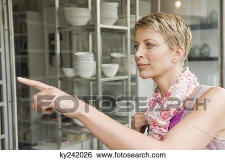 Woman window shopping in a store View Large Photo Image Stock Photograph - Woman window shopping in a store. Fotosearch
