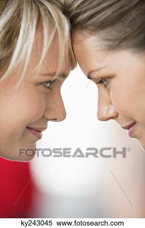 Close-up of two women smiling View Large Photo Image Stock Photography - Close-up of two women smiling. Fotosearch
