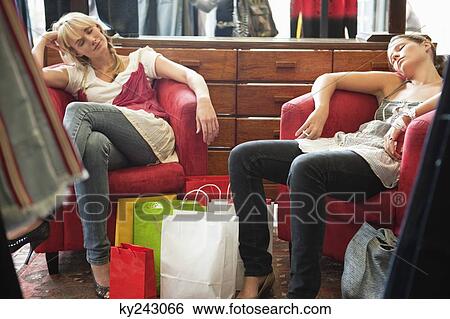 Two women napping in a boutique View Large Photo Image Stock Photograph - Two women napping in a boutique. Fotosearch