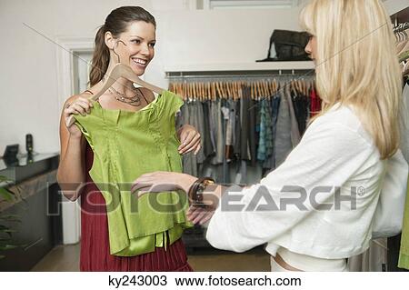 Two women shopping in a boutique View Large Photo Image Stock Image - Two women shopping in a boutique. Fotosearch