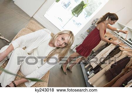 Stock Photo - Two women shopping in a boutique. Fotosearch
