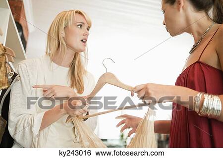 Stock Photograph - Two women shopping in a boutique. Fotosearch