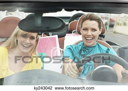 Two women sitting in a car after shopping View Large Photo Image Stock Image - Two women sitting in a car after shopping. Fotosearch