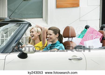 Two women sitting in a car after shopping View Large Photo Image Stock Image - Two women sitting in a car after shopping. Fotosearch