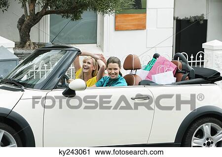Two women sitting in a car after shopping View Large Photo Image Stock Image - Two women sitting in a car after shopping. Fotosearch