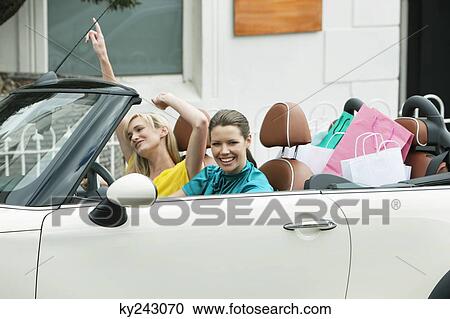 Two women sitting in a car after shopping View Large Photo Image Stock Image - Two women sitting in a car after shopping. Fotosearch