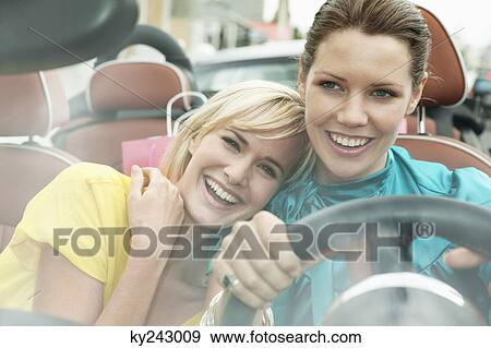 Two women sitting in a car after shopping View Large Photo Image Stock Photo - Two women sitting in a car after shopping. Fotosearch