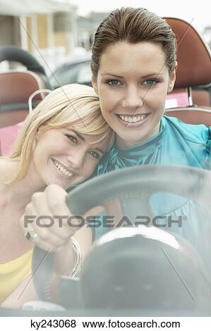 Two women sitting in a car after shopping View Large Photo Image Stock Photo - Two women sitting in a car after shopping. Fotosearch