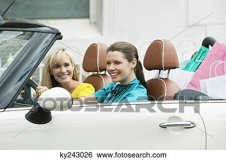 Two women sitting in a car after shopping View Large Photo Image Stock Photograph - Two women sitting in a car after shopping. Fotosearch