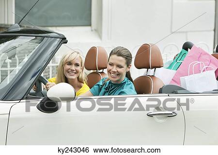Two women sitting in a car after shopping View Large Photo Image Stock Photograph - Two women sitting in a car after shopping. Fotosearch