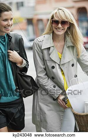 Two women walking with shopping bags View Large Photo Image Stock Photo - Two women walking with shopping bags. Fotosearch
