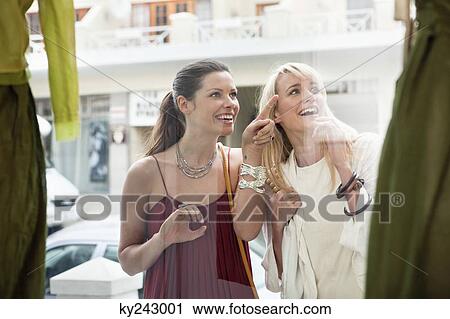 Two women window shopping outside a store View Large Photo Image Stock Image - Two women window shopping outside a store. Fotosearch