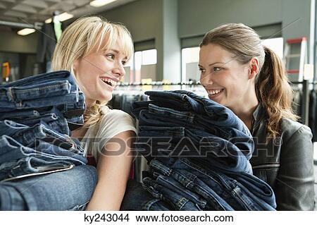 Women choosing dresses in a boutique View Large Photo Image Picture - Women choosing dresses in a boutique. Fotosearch