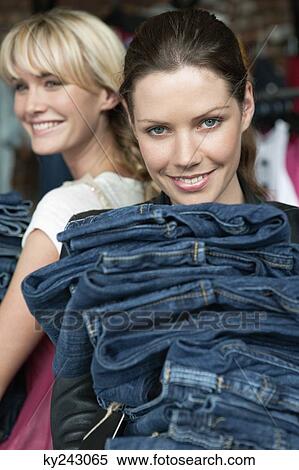 Women choosing dresses in a boutique View Large Photo Image Stock Photography - Women choosing dresses in a boutique. Fotosearch