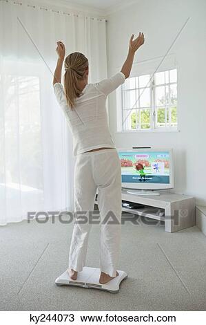 Woman doing step aerobics and watching TV View Large Photo Image Stock Image - Woman doing step aerobics and watching TV. Fotosearch