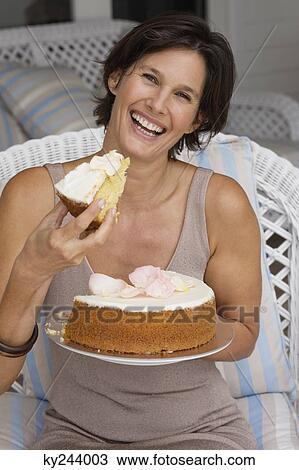 Stock Image - Woman holding a cake. Fotosearch