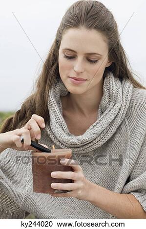 Woman lighting a candle with a cigarette lighter View Large Photo Image Stock Image - Woman lighting a candle with a cigarette lighter. Fotosearch