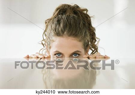 Woman peeking over a dining table View Large Photo Image Stock Image - Woman peeking over a dining table. Fotosearch