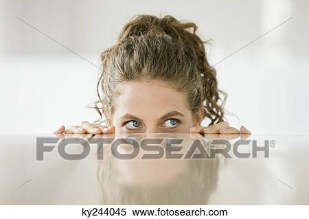 Woman peeking over a dining table View Large Photo Image Stock Photography - Woman peeking over a dining table. Fotosearch