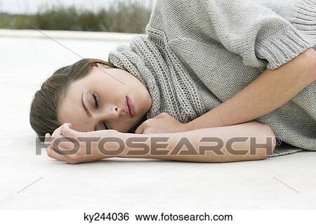 Stock Photograph - Woman resting on the floor. Fotosearch