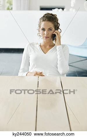 Woman talking on a mobile phone View Large Photo Image Stock Image - Woman talking on a mobile phone. Fotosearch