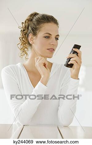 Stock Photo - Woman using a mobile phone. Fotosearch